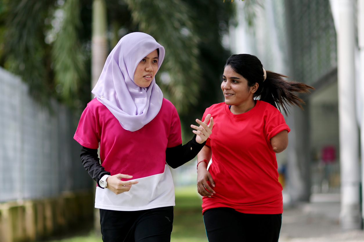 muslim woman and Indian woman with limb missing