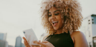 black woman agoes wow on mobile phone- emotion design masterclass