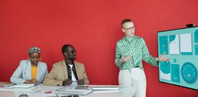 white female designer presents concepts to two black stakeholders